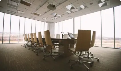 Modern conference room with a large table and chairs.
